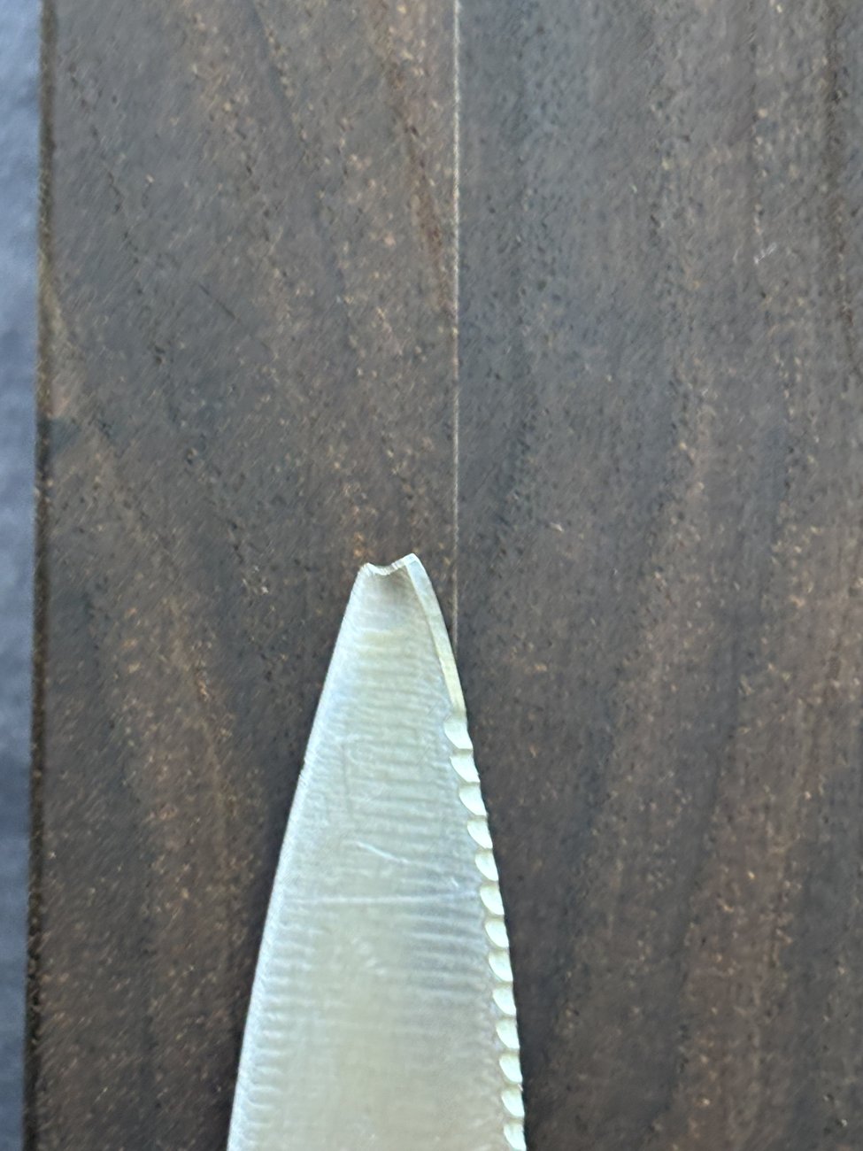 Knife with a chipped, broken tip before repair