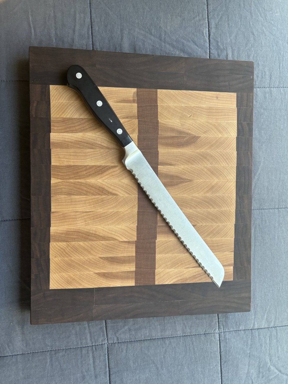 Serrated bread knife on a wooden cutting board
